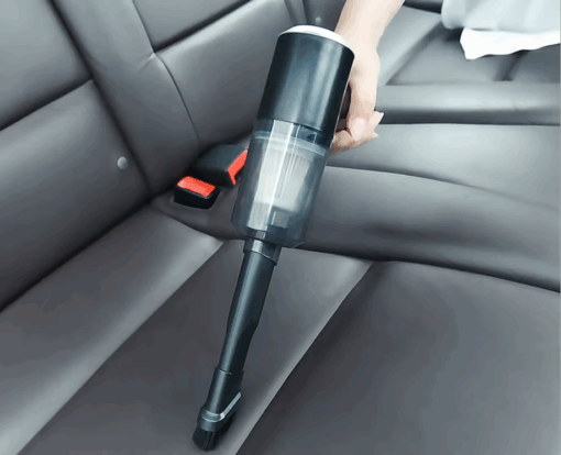 Vacuum being used to clean car seats
