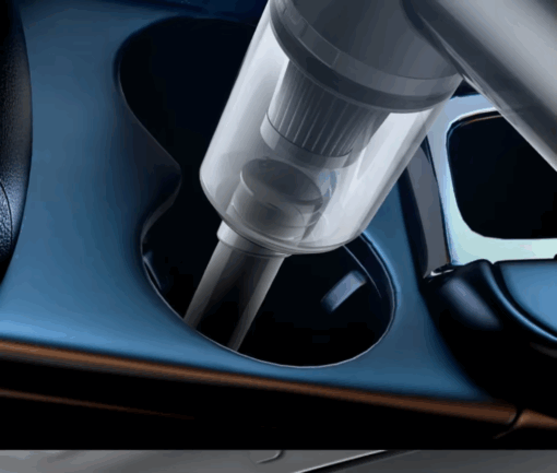 Vacuum being used to clean car cup holder