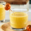 Close-up of Pasabahce Rain textured glass filled with golden pumpkin drink