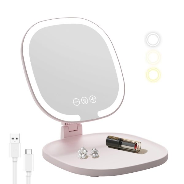 Pink Rechargeable LED Travel Makeup Mirror illuminated on a vanity table.