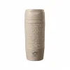 Momaz 300ml double-wall insulated stainless steel travel mug in beige with embossed coffee words and matching beige lid, isolated on a white background.