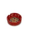 An 8 cm red handcrafted ceramic ashtray with a traditional floral pattern center.