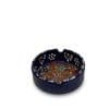 An 8 cm blue handcrafted ceramic ashtray with a multicolored floral pattern.