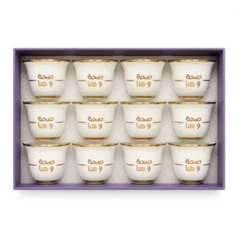 Set of 12 white Arabic coffee cups with gold rims and “صحة وهنا” printed in Arabic