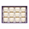 Set of 12 white Arabic coffee cups with gold rims and “شرفتونا” printed in Arabic
