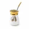 White and gold ceramic yerba mate cup with feather design, filled with mate and supplied with a metal bombilla