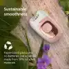 A VGR pink and white epilator placed on a rustic stone background, surrounded by green leaves and purple flowers. Text on the left reads 