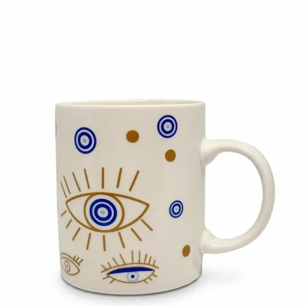 A white ceramic mug featuring a gold and blue evil eye pattern, displayed on a clean white background