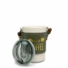 A portable white ceramic coffee mug with a green leather sleeve, gold 