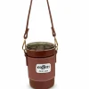 A brown portable coffee tumbler with a leather-style sleeve and shoulder strap.