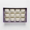 A 12-piece set of white ceramic Arabic coffee cups with gold "شرفتمونا" calligraphy in a gift box,