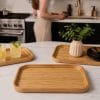A Natural Bamboo Serving Tray set of 3 arranged on a white kitchen counter.