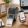 Green Lion thermal printer printing shipping label with phone app on desk