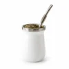White yerba mate cup with stainless steel rim, filled with mate and supplied with a metal bombilla