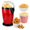 Red electric popcorn maker with transparent lid, popcorn kernels and freshly prepared popcorn