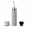 Gray yerba mate travel bottle disassembled showing metal straw, stainless cap, and sealed cap