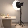 LED softbox light illuminating a perfume bottle for product photography